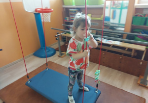Dziewczynka ćwiczy na podwieszeniu Neurac