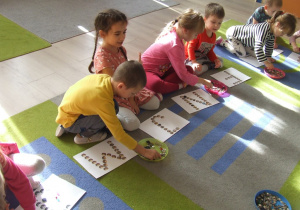 Dzieci układają litery wg wzoru.