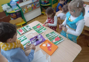 Dzieci wykonują ilustrację bajki "Czerwony Kapturek".
