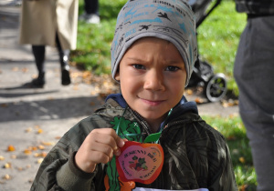 Dziecko prezentuje medal - jabłko.