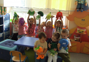 Dzieci prezentują pluszowe warzywa i owoce.