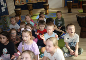 Dzieci wsłuchują się w muzykę.