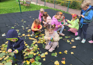 Dzieci nawlekają liście na druciki kreatywne.