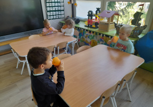 Dzieci piją zrobiomy przez siebie mus.