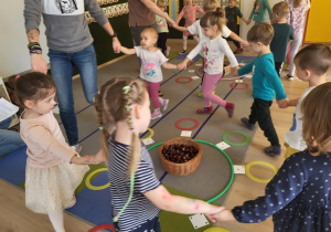 Dzieci bawią się w grę z liczbami i kasztanami.