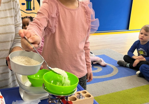 Dziecko nastypuje maki na szalkę.