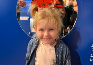 Dziewczynka pozuje do zdjęcia.