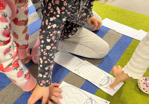 Dzieci wybieraja obrazek z Mikołajem.