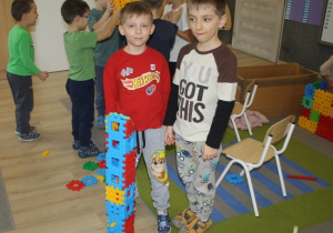 Dzieci budują rakietę z klocków.