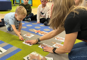 Chłopiec dokłada do piernkowego domku nr 2, dwa pierniczki.