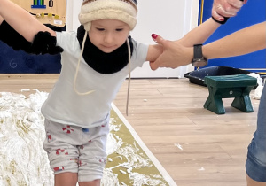 Dziecko jedzie po folii.