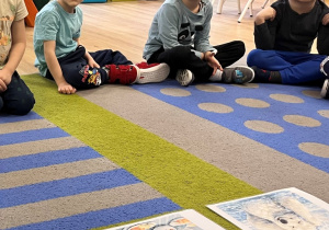 Dzieci słuchają opowidania z obrazkami.