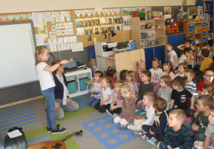 Dziecko gra na kołatce.