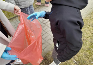 Wrzucanie śmieci do worka.