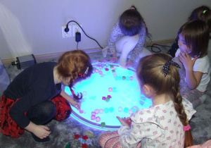 Dziewczynki układają zimowy pejzaż.