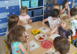 Dzieci jedzą przygotowane przez siebie babeczki.