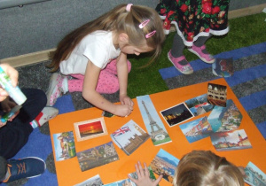 Dzieci przyklejają elementy do wielkiej europejskiej pocztówki.